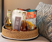 Amara Sanctuary welcome amenity basket with Hey! Chips packs and winefor VIP guests.