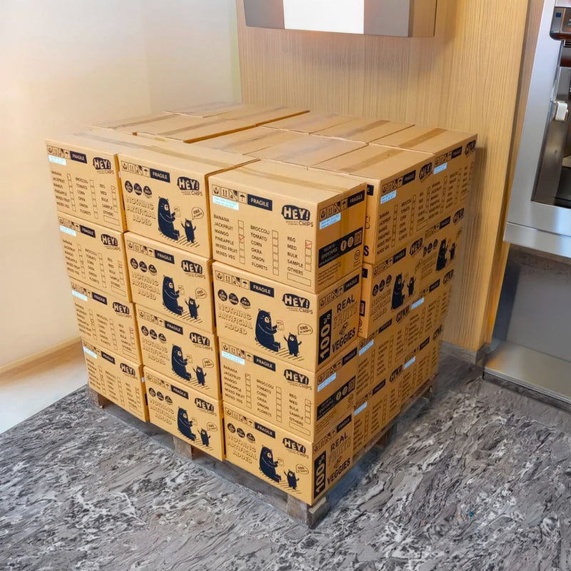Stack of HEPA filter boxes in a room with a window and wall.